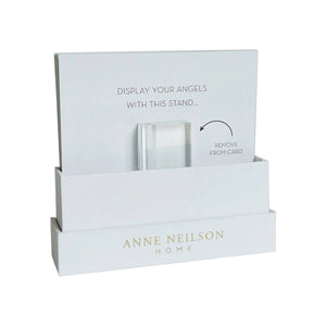 A white Anne Neilson display stand holds an instruction card for displaying Anne Neilson: Hope Scripture Cards. Remove the clear stand from the card to showcase inspirational Bible verses or scripture cards.