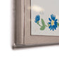 Close-up of the "Habitat Naturelle 1 by Paule Marrot" framed artwork from Soicher Marin, featuring part of a blue flower and green leaf design in the lower right corner against a neutral background, inspired by Paule Marrot prints for an elegant touch.