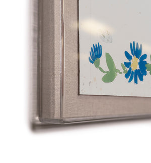 Close-up of the "Habitat Naturelle 1 by Paule Marrot" framed artwork from Soicher Marin, featuring part of a blue flower and green leaf design in the lower right corner against a neutral background, inspired by Paule Marrot prints for an elegant touch.