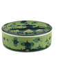 A round green ceramic box with a fitted lid, featuring dark blue floral and geometric designs inspired by Ginori 1735’s Oriente Italiano Malachite Dinnerware Collection.