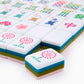 The Oh My Mahjong Tile Collection offers colorful, hand-painted mahjong tiles with floral and traditional designs for an enhanced gaming experience. The "Joker" tiles feature a unique dot pattern, elegantly showcasing the brand "Oh My Mahjong.