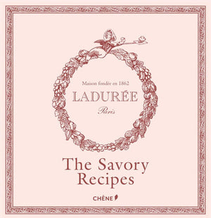 A pale pink book cover adorned with a floral wreath, featuring the text “Ladurée” and the title “The Savory Recipes” in bold lettering beneath—evoking the charm of the renowned Parisian tea salon where the macaron originated—published by Simon & Schuster.