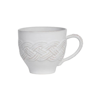 The Juliska Le Panier Mystic Knot Collection white ceramic mug showcases signature hand-knotted braid details and a textured pattern around the body and handle, set against a sleek white background.
