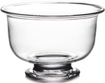 The Simon Pearce Revere Bowl Collection features clear glass bowls with wide round openings and sturdy pedestal bases, expertly handmade by glassblowers using centuries-old techniques. Shown empty against a white background.