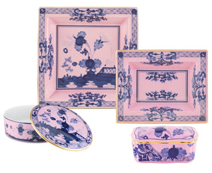 The Oriente Italiano Azalea Serveware & Decor Collection by Ginori 1735 features two square plates, a round lidded box, and a rectangular lidded box with blue floral patterns to add charming style to your home décor.