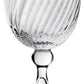The Venetia Drinkware Collection by William Yeoward Crystal features clear goblets with round bases, elegant stems with spherical details, and bowls adorned with textured diagonal swirls inspired by Venetian glassmaking.