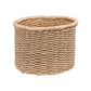 The Yuma Round Basket by Pigeon & Poodle, crafted from natural fibers with a subtly flared rim and shown on a white background, offers an elegant and practical storage solution.