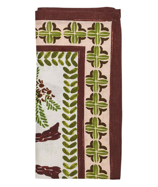 The Kim Seybert Oasis Napkins, Set of 4, showcase an elegantly folded cloth design with intricate floral and geometric patterns in green and brown hues, embodying a tropics-inspired island style.