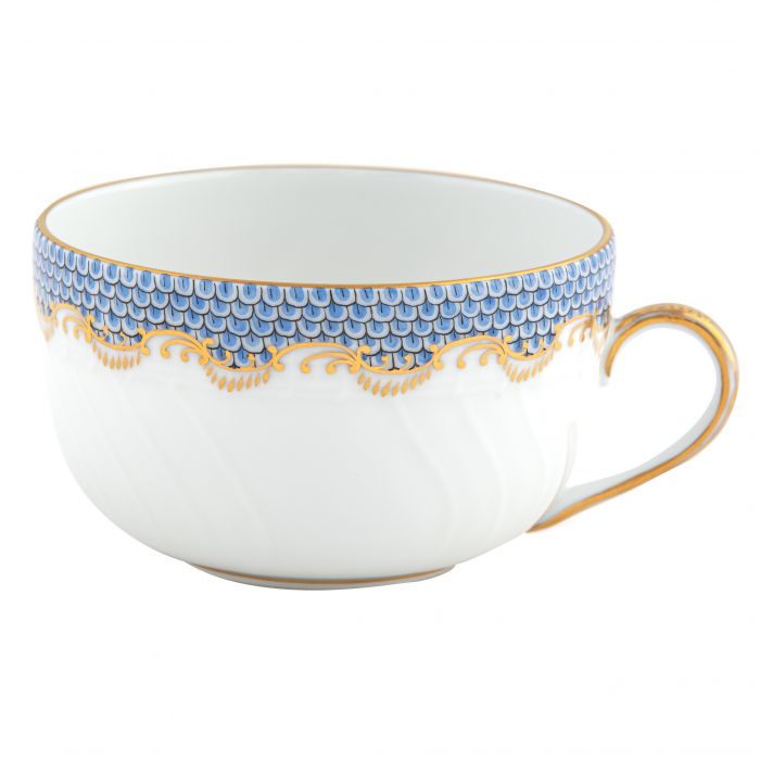 White ceramic teacup from the Herend Fish Scale Light Blue Collection by Herend, adorned with a gold and blue scalloped pattern along the rim, showcasing hand-painted designs on Herend porcelain, and featuring a gold-trimmed handle.