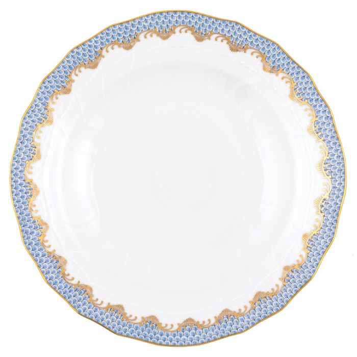 A plate from the Herend Fish Scale Light Blue Collection, featuring a sophisticated blue and gold scalloped pattern along the rim, embodies Herend's famed hand-painted designs, exuding true artistic appreciation.
