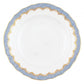 The Herend Fish Scale Light Blue Collection by Herend features a white porcelain plate with a scalloped edge, adorned with a blue and gold decorative pattern around the rim. The hand-painted designs elevate its artistic appreciation.