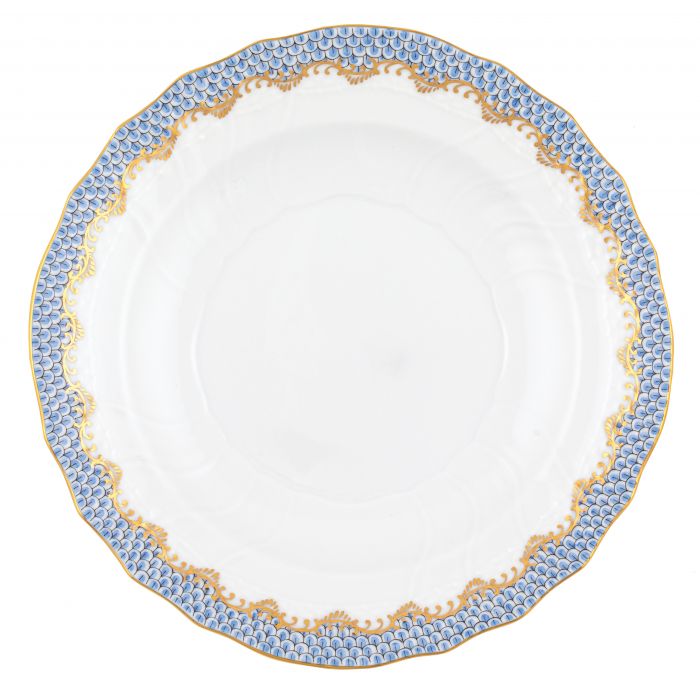 The Herend Fish Scale Light Blue Collection by Herend features a white porcelain plate with a scalloped edge, adorned with a blue and gold decorative pattern around the rim. The hand-painted designs elevate its artistic appreciation.