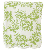 A neatly folded towel from the Weezie Towels x Meg Braff Bath Collection, featuring a green floral pattern and scallop trim, exudes Palm Beach elegance.