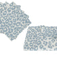 Six light blue and white leopard print cloth napkins from Matouk’s Iconic Leopard Sky Tabletop Collection, with four stacked on the left and two laid flat on the right.