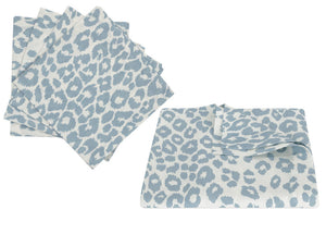 The Matouk Iconic Leopard Sky Tabletop Collection features Blue and White animal print napkins, beautifully presented with one set folded and another unfolded.