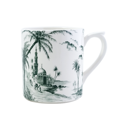 The Depareillees Vert Dinnerware and Serveware Collection by Gien France features a white ceramic mug with iconic black and white illustrations of palm trees, a domed mosque, minaret, and nearby figures—perfect for your unique collection or table.