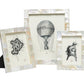 The Lesina Frame Collection by Pigeon & Poodle features three elegant white kabibe shell tile frames displaying black and white vintage illustrations—a letter P, hot air balloon, and diving helmet—to add coastal charm.