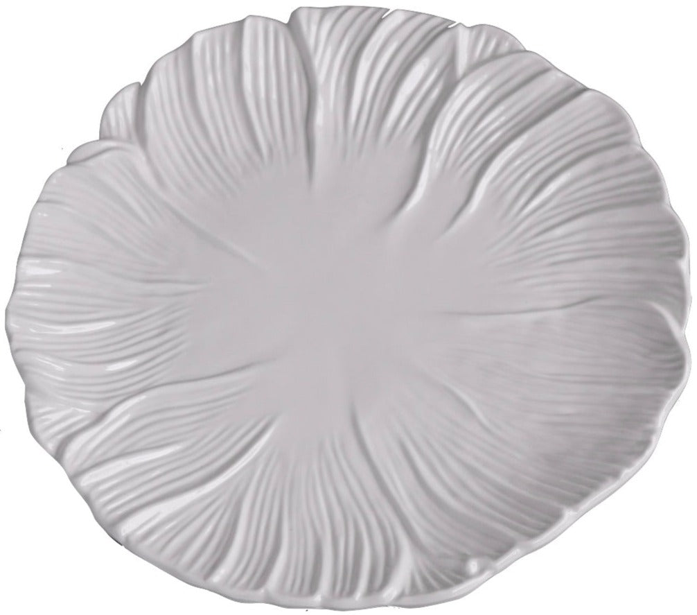 A white ceramic plate from the Vida Lettuce Dinnerware Collection by Beatriz Ball features a textured, leaf-inspired pattern radiating outward from the center.