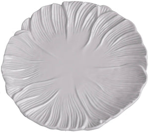 A white ceramic plate from the Vida Lettuce Dinnerware Collection by Beatriz Ball features a textured, leaf-inspired pattern radiating outward from the center.