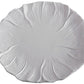 A white ceramic plate featuring a textured, floral petal design inspired by the Vida Lettuce Dinnerware Collection from Beatriz Ball.