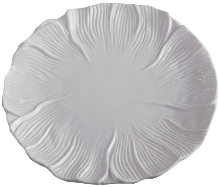 A white ceramic plate featuring a textured, floral petal design inspired by the Vida Lettuce Dinnerware Collection from Beatriz Ball.
