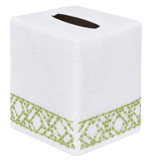 The Lido Bath Collection by Haute Home features a white tissue box cover with a rectangular opening on top, crafted from premium linen and adorned with green embroidered geometric patterns along the bottom edge—a stylish addition to your home décor.