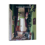 My Life in Colors" by Penguin Random House features a vibrant interior hallway on its cover, reflecting the colorful storytelling and glamorous style found throughout the book.