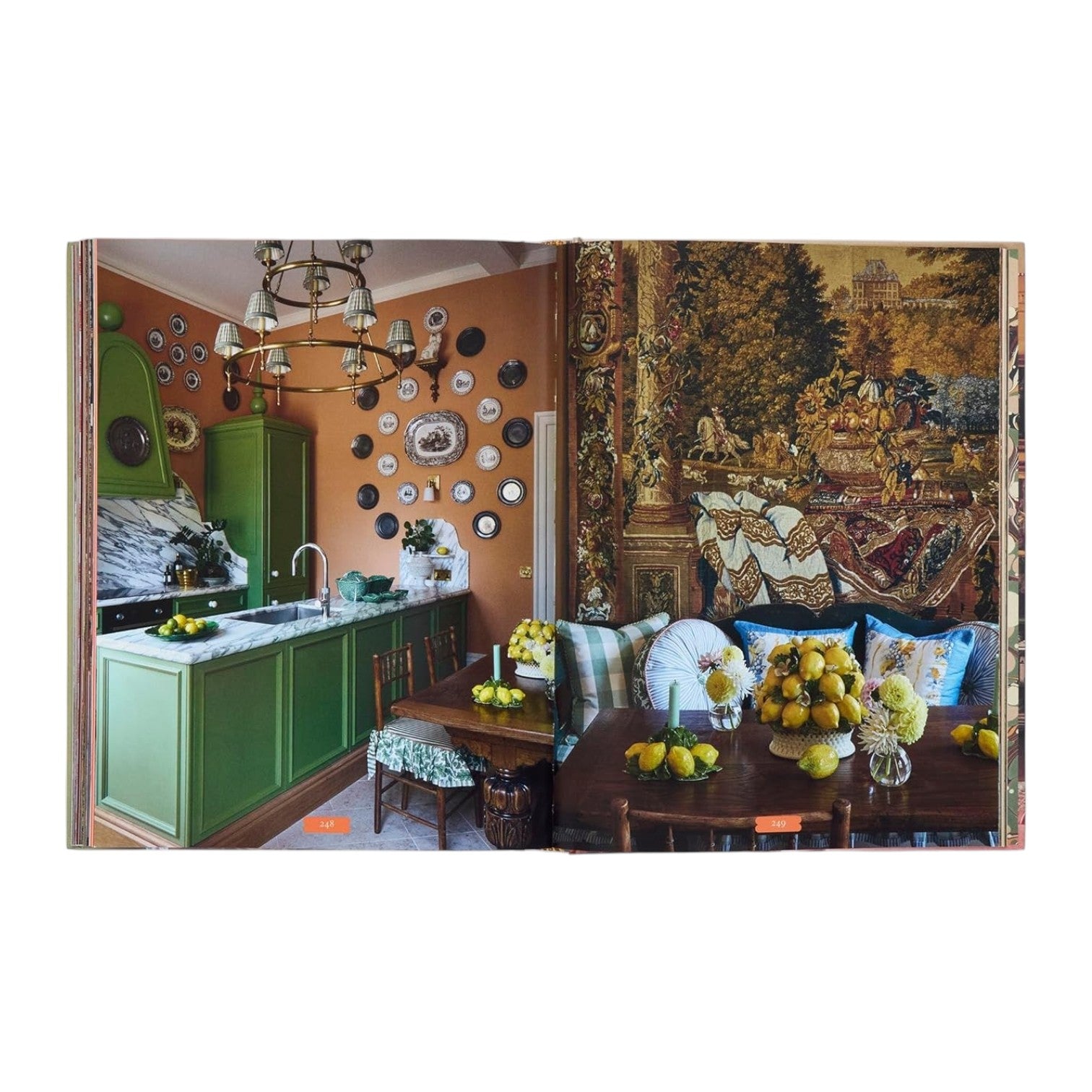 A kitchen and dining area inspired by My Life in Colors from Penguin Random House uses green cabinets, orange walls, and decorative plates to create a cozy space with a tapestry, patterned cushions, and bowls of lemons.