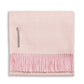Alicia Adams Alpaca's Classic Herringbone Throw Collection features a folded, light pink alpaca blanket with fringe edges and a small fabric label, all fair trade made in Peru.