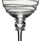A clear wine glass from the Juliska Amalia Drinkware Collection, featuring a decorative spiral along the bowl and a signature round accent on one side.
