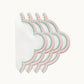 Four white linen napkins from the Duggan Society’s Lilibeth Table Linen Collection, with scalloped edges, pink borders, and green dot accents, are fanned out on a plain background for an elegant decorative touch.
