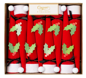 Caspari’s Santa Hat Cone Cracker Set includes 8 Christmas crackers shaped like Santa hats, each with a holly and berry cutout—festive party favors ideal for any holiday celebration.