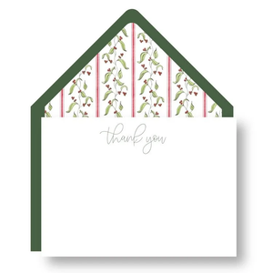 The Spruce Thank You Note Set by Haute Papier includes plain white cards with “thank you” in cursive and green envelopes, featuring decorative floral and striped liners.
