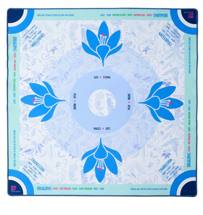 The Oh My Mahjong Mahjong Mat Collection features a square neoprene mat with blue floral designs, labeled "walls" and "left" sections, printed edge instructions, and a non-slip surface for stable gameplay.