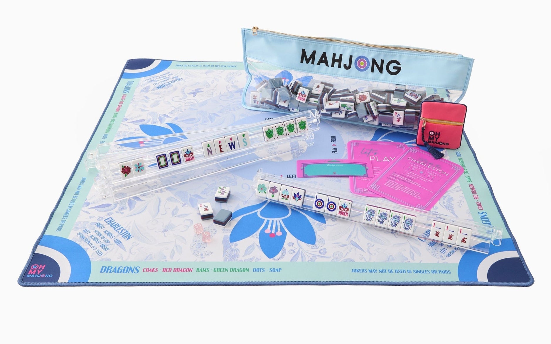 The Oh My Mahjong Mat Collection includes tiles, racks, a neoprene non-slip playmat, instructions, and a scorecard—all organized in an Oh My Mahjong branded zipper pouch.