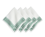 The Juliska Iberian Evergreen Border Napkin Set, featuring four linen napkins adorned with a green leafy Iberian-inspired border, is neatly arranged in a row with a slight overlap—perfect for adding elegant charm to your table settings.
