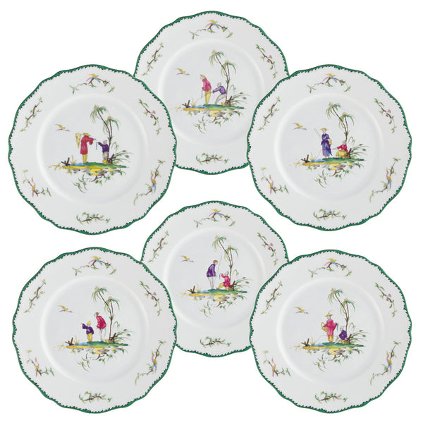 The Raynaud Longjiang Collection by Raynaud consists of a set of six decorative plates adorned with vibrant oriental-style designs, featuring intricate figures, trees, and birds. The rims are embellished with a green patterned border that evokes the timeless elegance of classic faience dinnerware.