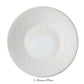 A round, light-toned ceramic plate with a subtle textured pattern and elegant perle glaze from Jars' Vuelta White Pearl Collection, labeled "L Dinner Plate" below.