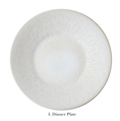 A round, light-toned ceramic plate with a subtle textured pattern and elegant perle glaze from Jars' Vuelta White Pearl Collection, labeled "L Dinner Plate" below.