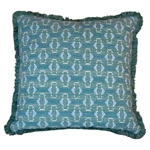 The Teal Sicily Outdoor Pillow by Associated Design features a blue geometric pattern with light blue and white accents and fringed edges, crafted from premium materials for a luxurious touch.