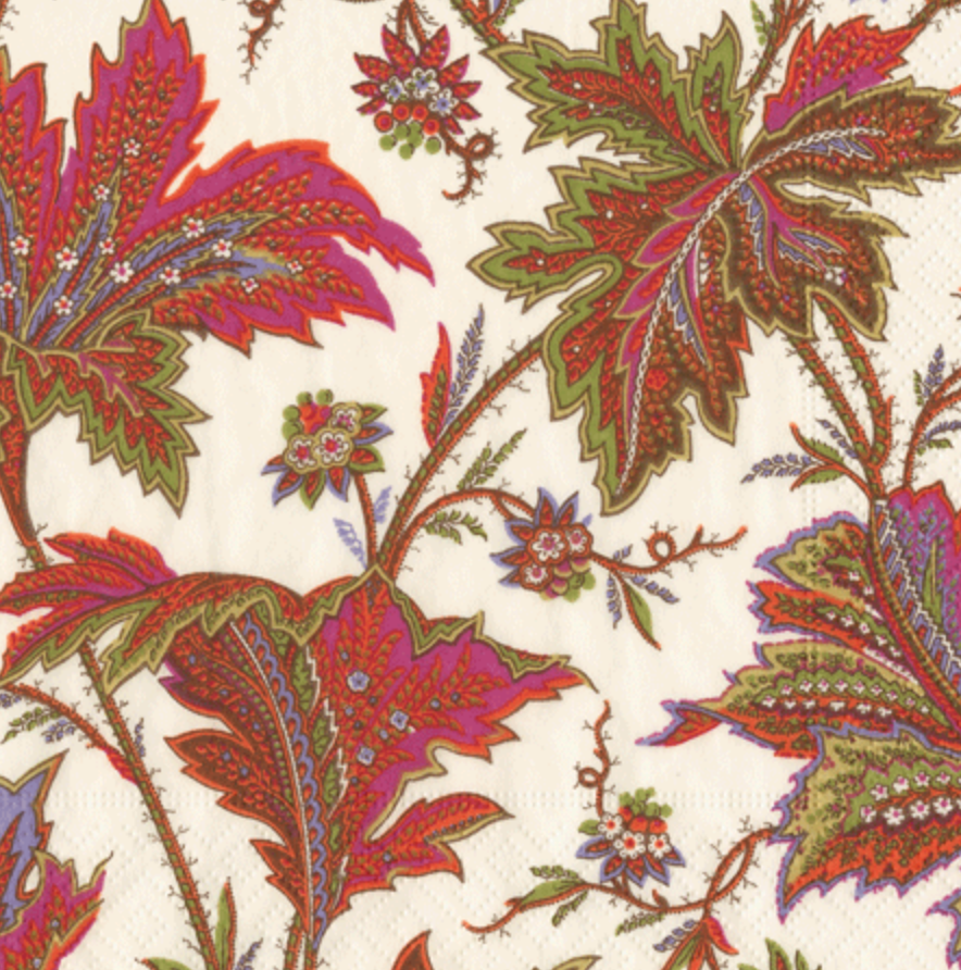 The Caspari Paisley Leaves Ivory Collection features a cream background adorned with large, intricate red, green, and purple leaves—perfect for elegant table settings or matching with party supplies.