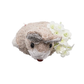 The Kim Seybert Easter Bunny Napkin Ring, a small beige bunny with black eyes, is shown beside white artificial flowers on a pristine background, creating a charming festive accent for your spring decor.