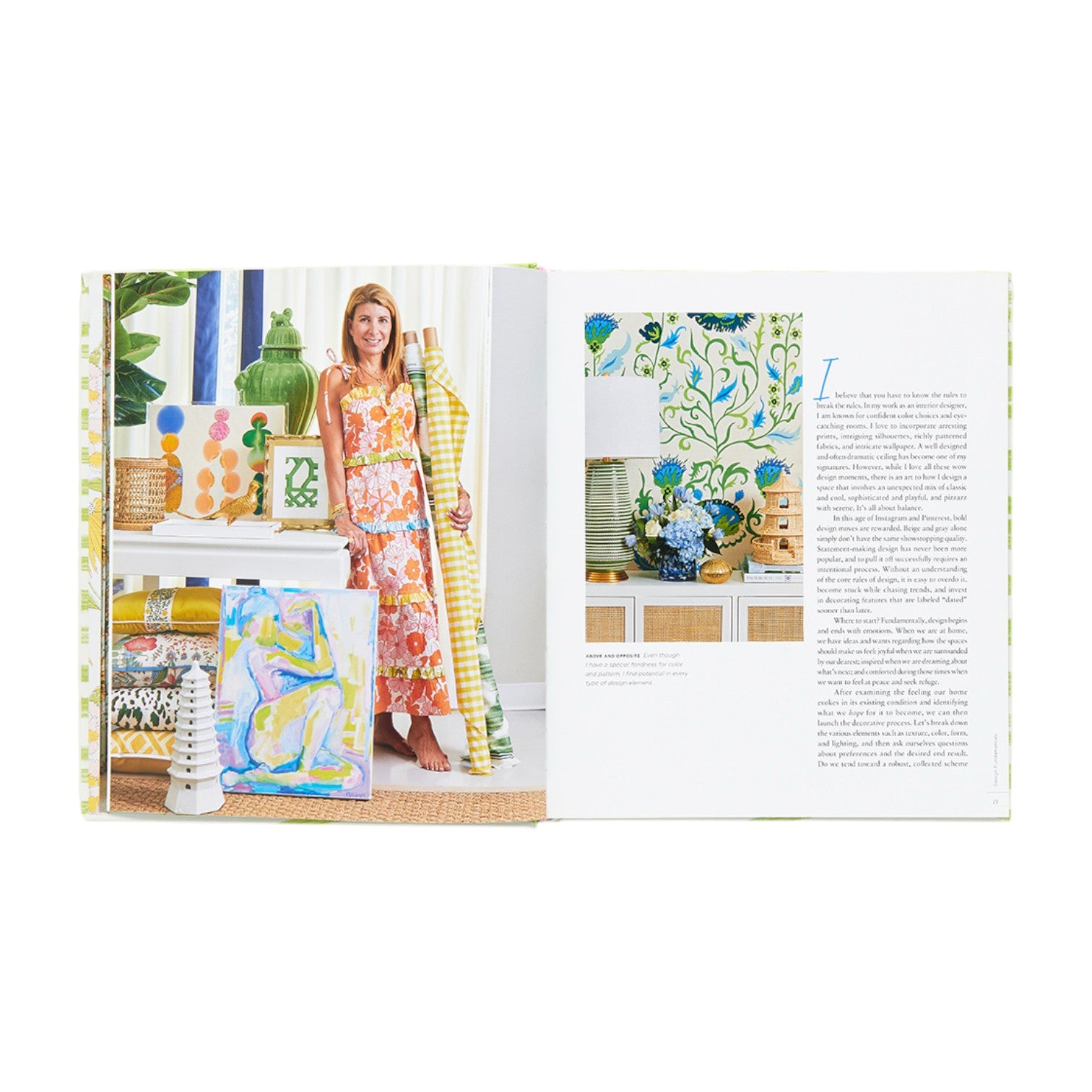 An open book displays "Designing Rooms With Joie de Vivre" by Abrams: Amanda Reynal holds patterned fabric rolls on the left, while the right shows a decorated interior and text about her fresh take on classic style.
