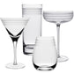 Four clear glass pieces from the Madison Drinkware Collection by William Yeoward Crystal—martini, highball, coupe, and tumbler—feature frosted rim stripes and evoke Jazz Age style against a white background.