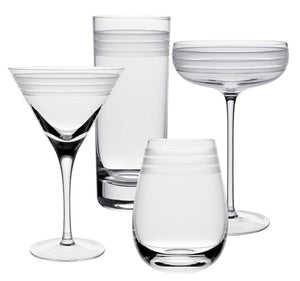 Four clear glasses from the William Yeoward Crystal Madison Collection—martini, highball, coupe, and stemless—feature frosted stripes and copper-wheel engraved lines near the rim, displayed against a white background.