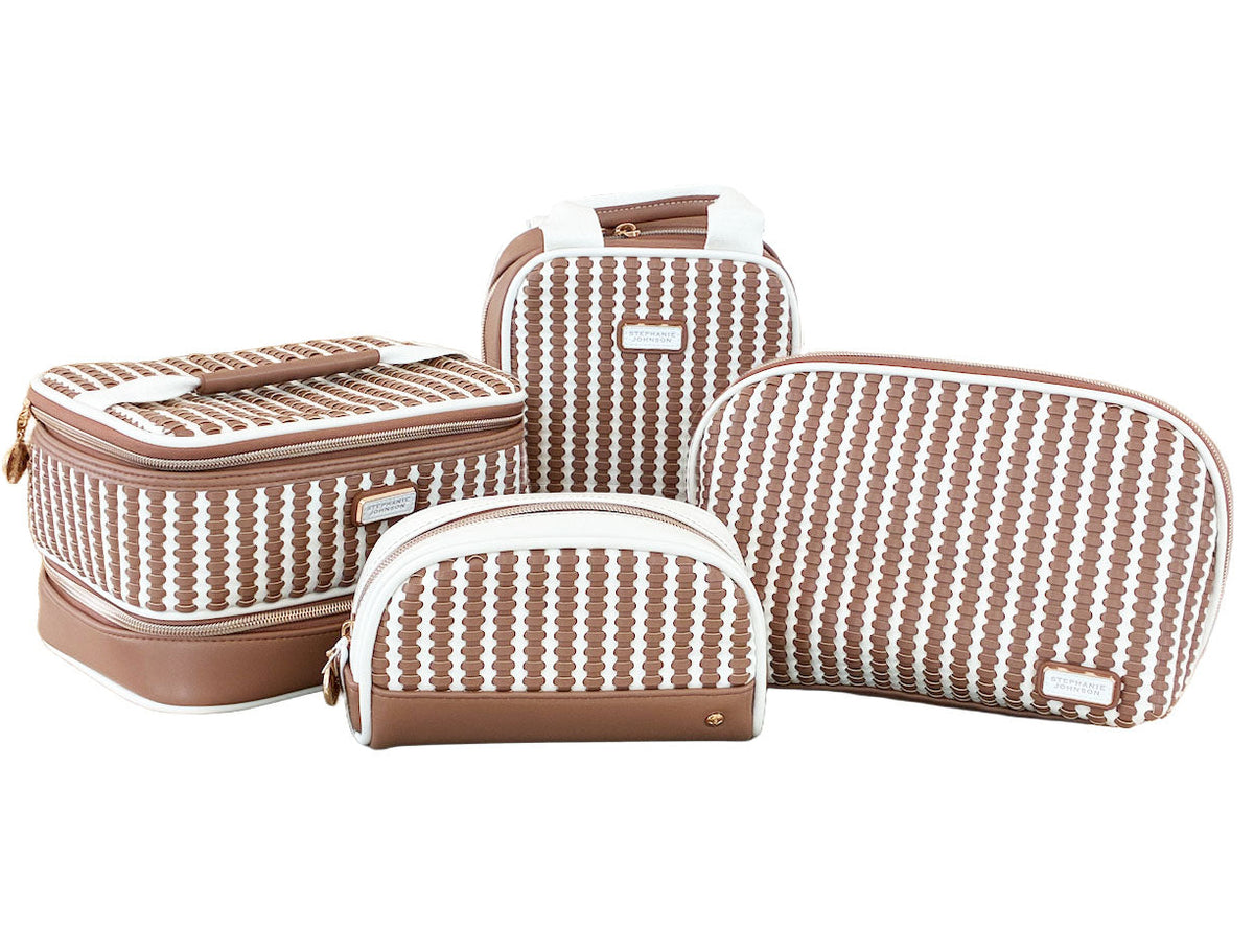 Four brown and white patterned bags from the Stephanie Johnson Marbella Mocha Travel Collection—including a stylish makeup bag and a compact mini pouch—are arranged together on a white background.