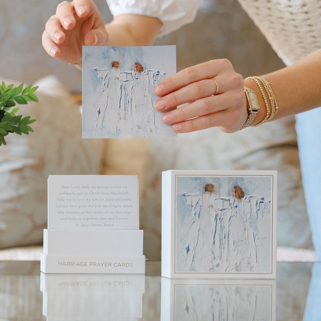 A person holds an Anne Neilson: Marriage Prayer Card featuring two birds on a branch above its box—a thoughtful wedding gift from Anne Neilson, filled with printed prayers for newlyweds.