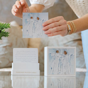 A person holds an Anne Neilson: Marriage Prayer Card featuring two birds on a branch above its box—a thoughtful wedding gift from Anne Neilson, filled with printed prayers for newlyweds.