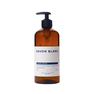 A 500ml brown plastic pump bottle from the Savon Blanc Soap Collection, featuring a chic white and blue label with "Made in France"—ideal for anyone who values natural beauty in daily routines.