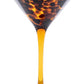 The Puro Tortoiseshell Drinkware Collection by Juliska features a martini glass in amber and brown hues that elevates any handcrafted cocktail, shown against a white background.